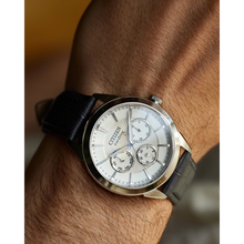 Load image into Gallery viewer, Citizen watch on a wrist with a blurred background