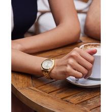 Load image into Gallery viewer, Person wearing a gold watch with a cup of coffee on a wooden table