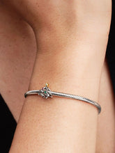 Load image into Gallery viewer, Silver bracelet with a tree-shaped charm on a wrist against a neutral background