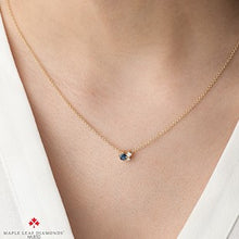 Load image into Gallery viewer, Gold necklace with a blue gemstone on a person's neck, brand 'Maple Leaf Diamonds' visible.