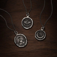 Load image into Gallery viewer, Three silver necklaces with circular pendants on a wooden surface