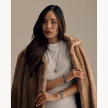 Load image into Gallery viewer, Woman wearing a fur coat over a plain background
