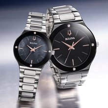 Load image into Gallery viewer, Two Bulova watches with black faces and silver metal bands on a gradient background
