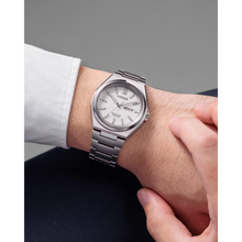Load image into Gallery viewer, Silver Citizen watch on a wrist with a gray background
