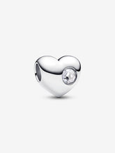 Load image into Gallery viewer, Silver heart-shaped charm with a clear gemstone on a white background
