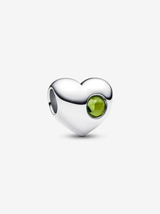 Heart-shaped silver charm with a light green gemstone on a white background