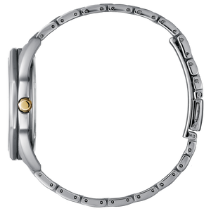 Close-up of a silver watch with a gold accent on a white background