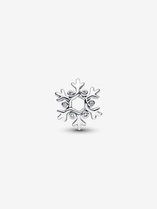 Silver snowflake-shaped charm with embedded stones on a white background