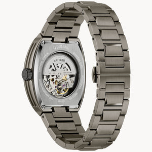 Gun colored watch with a detailed mechanical movement on a white background
