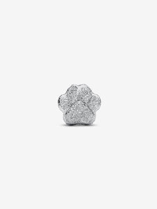 Silver paw print charm on a white background