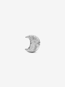 Silver crescent moon charm on a white background