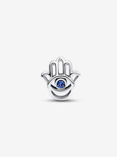Load image into Gallery viewer, Silver hamsa hand charm with a blue gemstone on a white background
