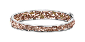 Rose gold bracelet with intricate design on a white background