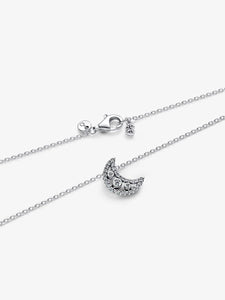 Silver necklace with a crescent moon pendant on a white background