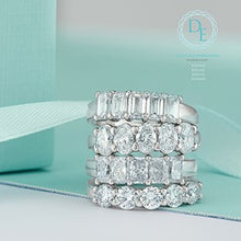 Load image into Gallery viewer, Four diamond rings stacked on a light blue ribbon with a soft background
