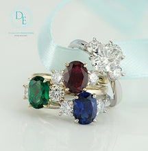 Load image into Gallery viewer, Three gemstone rings with emerald, ruby, and sapphire on a light background
