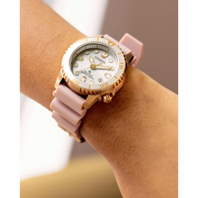 Load image into Gallery viewer, Wrist wearing a pink and gold watch with a white face.
