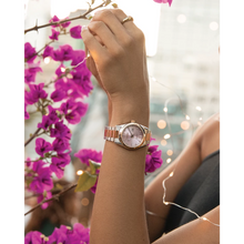 Load image into Gallery viewer, Hand wearing a watch with pink floral and string lights in the background

