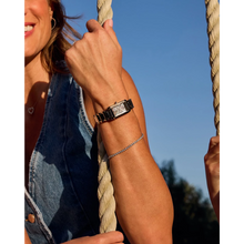 Load image into Gallery viewer, Person wearing a watch on a rope swing with a clear blue sky background
