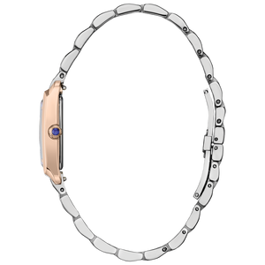 Close-up of a watch with a silver band and rose gold case on a white background