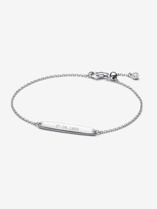 Silver bracelet with engraved date on a white background