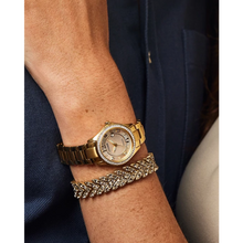 Load image into Gallery viewer, Gold watch and bracelet on a wrist with a blurred background
