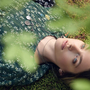 Symbol Charm layered with talismans worn by model