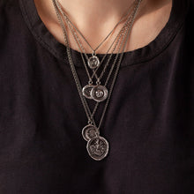 Load image into Gallery viewer, Necklace with talisman pendants on a black shirt
