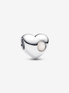 Heart-shaped silver charm with a white stone on a light gray background