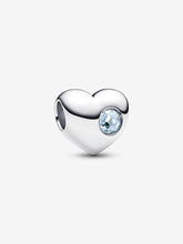 Load image into Gallery viewer, Heart-shaped silver charm with a pale blue gemstone on a white background
