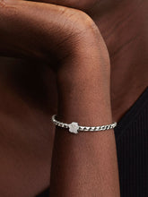 Load image into Gallery viewer, Silver bracelet on a wrist with a blurred background
