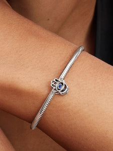 Silver bracelet with a blue stone on a wrist