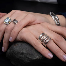 Load image into Gallery viewer, Close-up of a hand wearing multiple rings on a dark background
