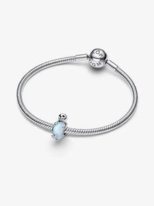 Silver bracelet with a seal-shaped opal charm on a white background