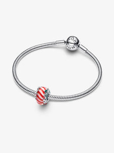 Silver bracelet with a red and white striped charm on a white background
