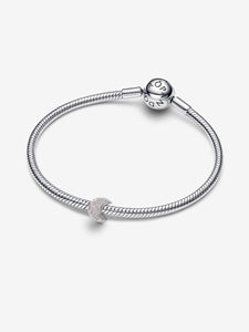 Silver bracelet with a heart charm on a white background