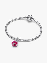Load image into Gallery viewer, Silver bracelet with a pink flower charm on a white background

