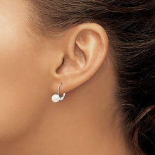 Load image into Gallery viewer, Close-up of an ear wearing a white gold earring with a pearl detail.
