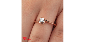 Rose gold ring with a diamond on a hand