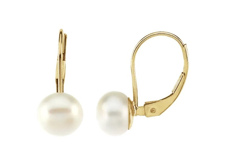 Pearl earrings with gold hooks on a white background