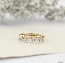 Load image into Gallery viewer, Two gold rings with intricate designs on a white surface.
