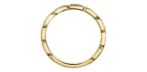 Gold ring with a textured band on a white background