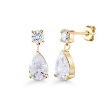 Load image into Gallery viewer, A pair of gold plated  drop earrings with a small round clear gemstone above a larger teardrop-shaped clear gemstone, shown on a plain white background.
