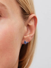 Load image into Gallery viewer, Close-up of a person wearing a blue butterfly earring on a plain background
