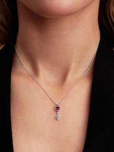 Load image into Gallery viewer, Necklace with a heart-shaped key pendant on a person's neck against a black background
