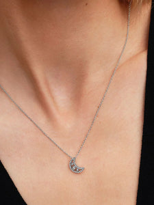 Necklace with a moon pendant worn by a person