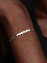 Load image into Gallery viewer, Silver bracelet on a person&#39;s wrist against a dark background
