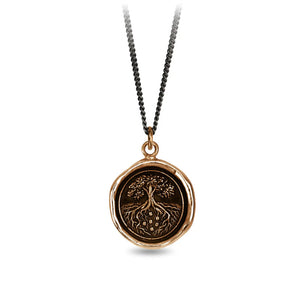 Necklace with a bronze pendant featuring an engraved design on a white background