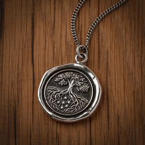 Silver pendant on a wooden background
