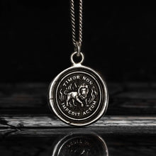 Load image into Gallery viewer, Silver pendant with lion design and engraved text on a dark background
